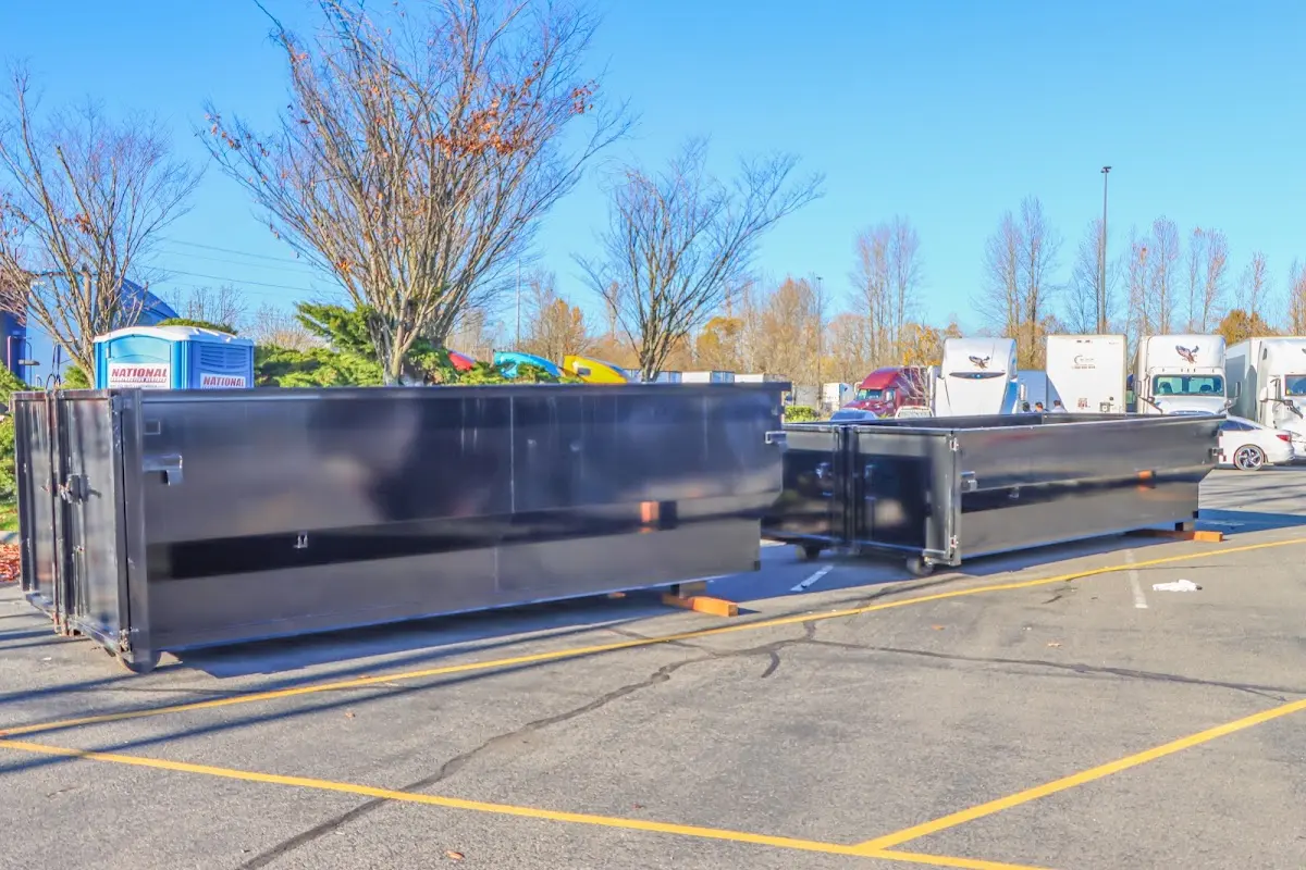 Professional dumpster rental service with roll-off container on residential driveway in Fountain Inn